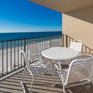 Enjoy meals or morning coffee at the round table surrounded by comfortable chairs, with expansive views of the beach