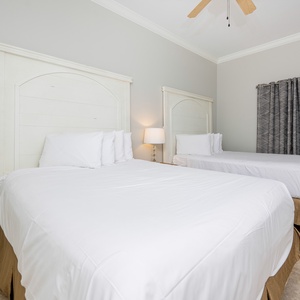 Rest peacefully in this inviting guest bedroom featuring two queen beds and soft lighting for a relaxing vibe