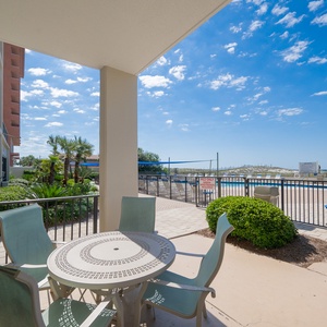 Enjoy easy pool access from this private patio featuring plenty of seating for morning coffee or afternoon relaxation