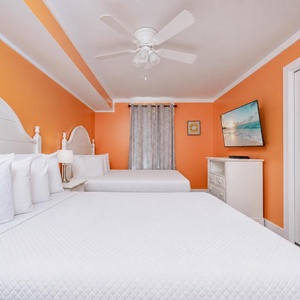 Two queen beds in the guest suite invite restful nights after a day filled with family fun and coastal adventure