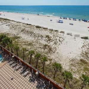 Take a dip in the inviting gradual entry pool while enjoying views of the beach and lounge area just steps away