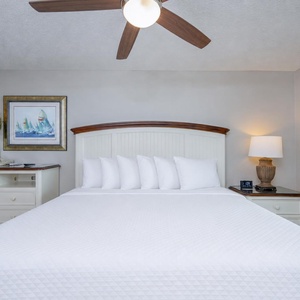 Unwind in this king master suite surrounded by calming decor, ready to embrace the beach vibe as you drift off to sleep