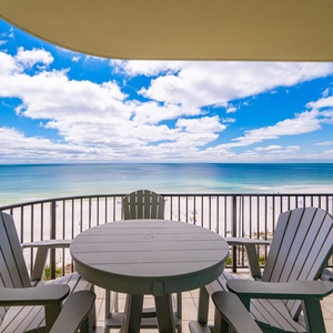 Breathe in the coastal vibe from your balcony as you relax at the round table, soaking in breathtaking beach views