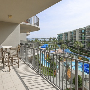 Feel the gentle breeze at the balcony table, soaking in picturesque views of the bay and the pool area