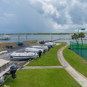 This view showcases a serene lagoon with boats docked nearby, perfect for a relaxing getaway or fishing adventure
