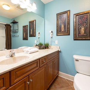 Experience the vibrant decor and spacious vanity as you prepare for your beach adventures in this lovely guest bath