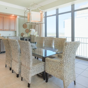 Gather around the sleek dining table with loved ones, enjoying meals while soaking in coastal views