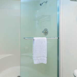 Glass-enclosed walk-in shower in the master bath for a refreshing experience after a day at the beach