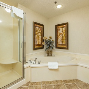 Indulge in relaxation with a spacious jetted tub, elegant decor, and a separate walk-in shower for your comfort