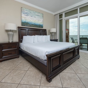 Retreat to the king master suite with cozy bedding and drift off to the sound of the waves from the balcony