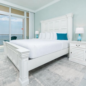 Retreat to the king master suite with cozy bedding and drift off to the sound of the waves from the balcony