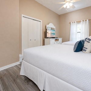 Enjoy your favorite shows on the TV in this welcoming guest room with two queen beds