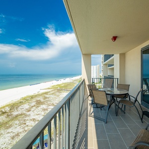Relax at the outdoor table while enjoying views of the tranquil water and beach from your spacious balcony