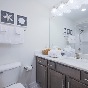 Refresh in this guest bath with a relaxing shower and stylish coastal decor during your beach retreat