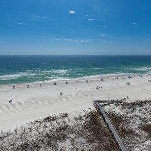 Endless blue horizon stretches before you as gentle surf brushes the powdery white sand beneath your feet