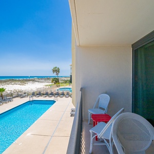 Savor the sunshine on your balcony, soaking in coastal views and the inviting ambiance of the sparkling pool