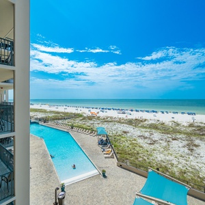 Take in the stunning views from your balcony, overlooking the pool and the beach with inviting lounge chairs