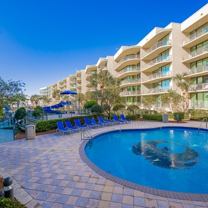 Relax by the sparkling pool, soaking in the sun amidst lush landscaping and inviting lounge chairs