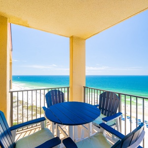 A serene beach scene features soft white sand and gentle waves under a bright blue sky dotted with fluffy clouds