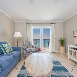 Soft light fills the living room as you unwind on the sofa watching waves sparkle along the shore