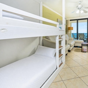 Bunk area with soft linens invites kids to dream while you enjoy beach views from the living room