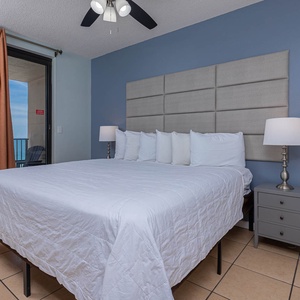 Relax in this inviting master suite featuring a spacious king bed, soft linens, and a view of the beach from the balcony