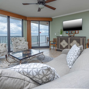 Relax in the inviting living area featuring a sofa with queen sleeper and stunning views through the large windows