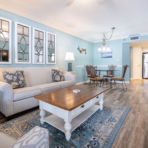 Relax in the inviting living area with a queen sofa sleeper, stylish decor, and a dining space for shared meals