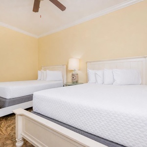 Soothing guest bedroom featuring two cozy queen beds and soft, neutral decor for a relaxing stay
