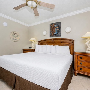 Relax in this inviting bedroom featuring a comfortable king bed, coastal decor, and a soothing atmosphere