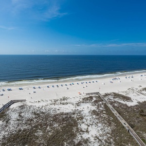 Sweeping views of the shoreline, where beach chairs and umbrellas invite you to relax by the water's edge