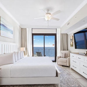 Unwind in this stunning master suite featuring a king bed, a large TV, and beach balcony access