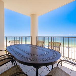 Enjoy meals and beach breezes on the spacious balcony with a stunning view of the pristine beach and blue waters