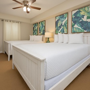 Queen guest suite with tropical artwork, creating a relaxed atmosphere