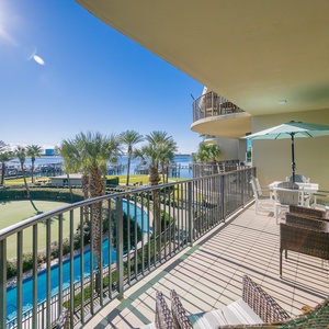 Savor the warmth of the sun while lounging on the balcony, surrounded by lush palms and peaceful bay views