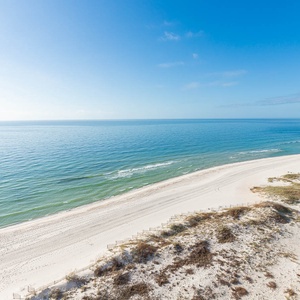 Gaze at the serene water and expansive shoreline, perfect for relaxation and enjoying nature's beauty