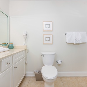 Freshen up in this guest bathroom, enjoying the easy access to fluffy towels and a rejuvenating shower