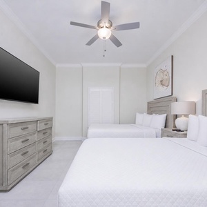 Relax on one of the cozy queen beds in this guest suite and stream your favorite shows after a beach day