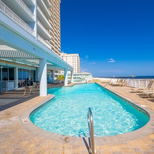 Relax by the pool with stunning beachfront views and easy access to the sandy shore just steps away