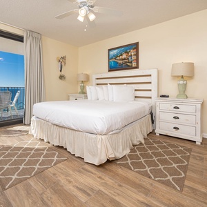 Relax in the inviting master bedroom featuring a comfortable king bed, stylish decor, and beachfront balcony access