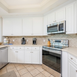 Prepare meals in this kitchen with elegant cabinetry, stainless appliances, and spacious countertops