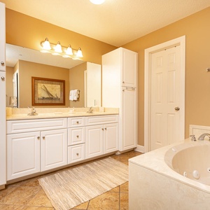 Refresh in the master bath after a day at the beach with a soothing jetted tub and relaxing walk-in shower