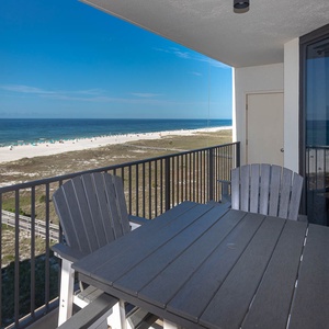 Relax on the balcony with a table and chairs, enjoying sweeping views of the beach and tranquil gulf waters