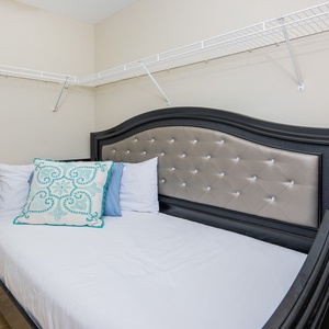 Cozy twin daybed adorned with decorative pillows in the master closet for added convenience