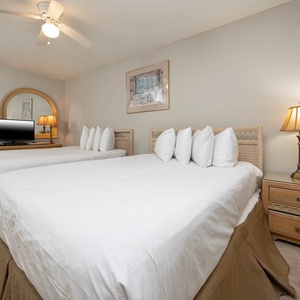 Inviting guest bedroom featuring two comfortable queen beds and a TV