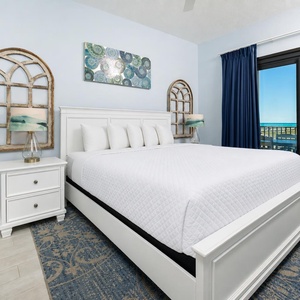 King bed in the master suite invites you to unwind and enjoy peaceful views from your balcony doors