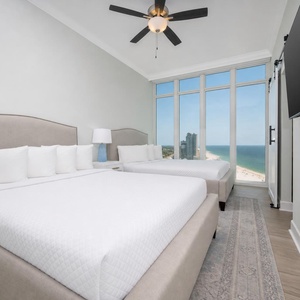 Wake to a breathtaking sunrise in this queen guest suite with two cozy beds and expansive views from the windows