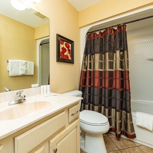 Towels await as you wash away the day in the cozy guest suite bathroom with a bubbling shower curtain texture