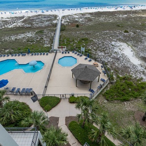 Overlooking the pool area, this view showcases inviting lounge chairs, a gazebo, and easy access to the beach beyond