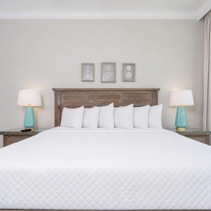 Relax in this king guest suite and admire the coastal artwork as curtains filter soft daylight
